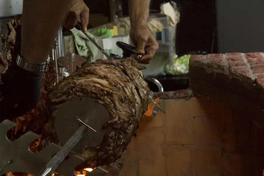 Usta cağ kebabını şişten keserken